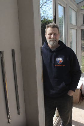 Olly standing by a door- BH Locksmiths