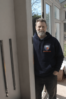 Olly standing by a door- BH Locksmiths